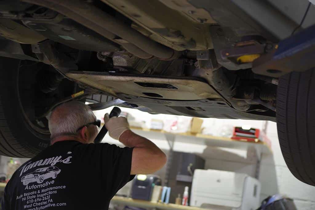 Mechanic under car for maintenance